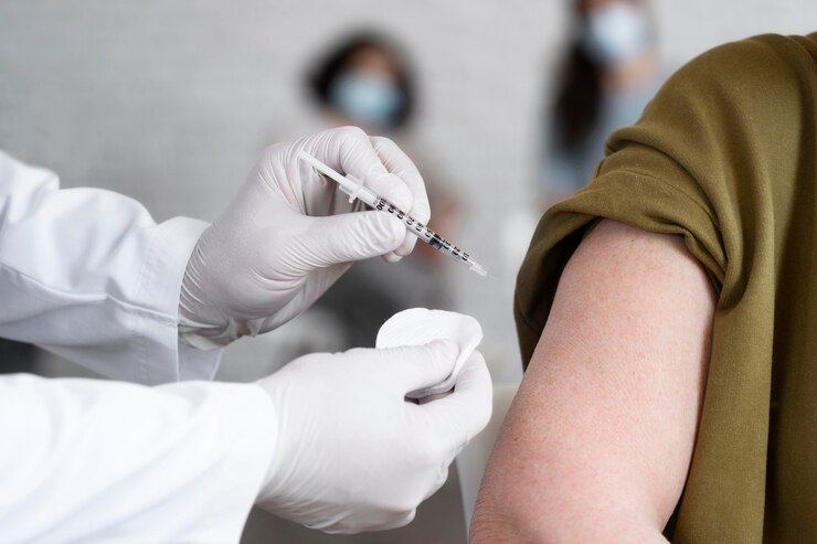 woman getting a vaccine shot by doctor